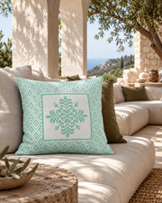 VITA Verde mint green cushion styled on an ivory sofa in a Mediterranean lounge